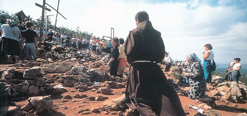 The hill of the apparitions, with a Franciscan among the pilgrims.