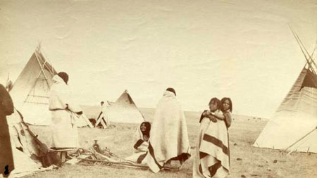 Young Indians with blankets offered by compassionate officials.